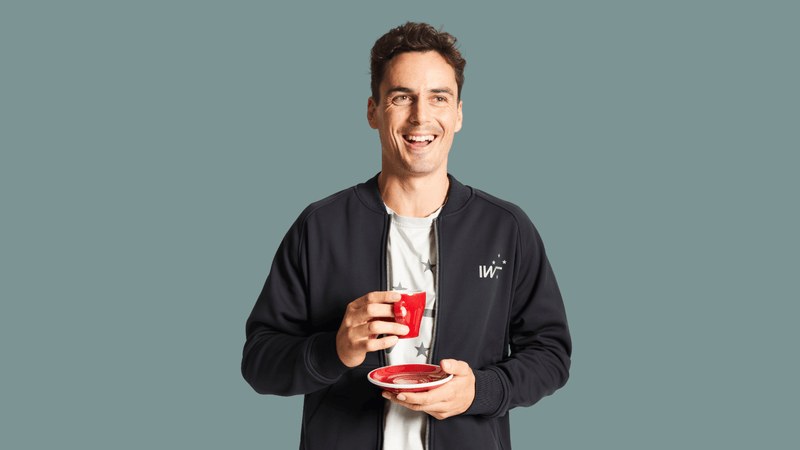 New Zealand Squash Player Paul Coll smiles with cup of coffee